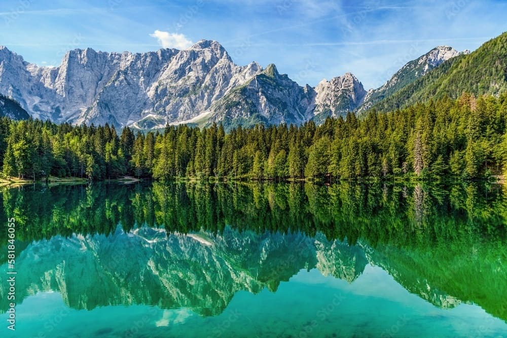 Lago di Fusine Superiore con riflesso delle Alpi Giulie